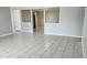 Bright living room featuring open concept layout, tile flooring, and freshly painted walls at 5507 Riddle Rd, Holiday, FL 34690