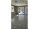 Cozy living room featuring tiled flooring, lots of natural light, and access to an enclosed patio at 5507 Riddle Rd, Holiday, FL 34690