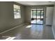 Inviting living room space featuring tiled flooring, lots of natural light, and access to an enclosed patio at 5507 Riddle Rd, Holiday, FL 34690