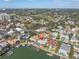 Wide aerial view showing the community with the house, golf course, buildings, and water access at 5836 Skimmer Point S Blvd, Gulfport, FL 33707