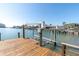 Dock with boat lift on a sunny day, highlighting waterfront living and recreational opportunities at 5836 Skimmer Point S Blvd, Gulfport, FL 33707