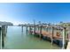 Dock on the water with a boat lift, showcasing waterfront lifestyle and recreational opportunities at 5836 Skimmer Point S Blvd, Gulfport, FL 33707