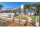 View of the property from the dock featuring a patio and stairway leading to the main house at 5836 Skimmer Point S Blvd, Gulfport, FL 33707