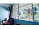 Relaxing balcony view with palm trees, blue skies and seating with glimpses of the community and the building across the street at 611 Destiny Dr # 604, Ruskin, FL 33570