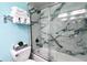 Bathroom showcasing a shower with glass doors and marble-patterned tiles at 611 Destiny Dr # 604, Ruskin, FL 33570