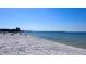 Beautiful sandy beach with clear blue water, inviting for a swim or sunbathing on a beautiful sunny day at 611 Destiny Dr # 604, Ruskin, FL 33570