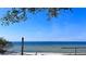 Scenic beach view of calm waters and a distant city skyline on a clear day, close to pier at 611 Destiny Dr # 604, Ruskin, FL 33570