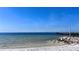 Picturesque beach view with a pier stretching into the ocean, set against a clear blue sky with distant city skyline at 611 Destiny Dr # 604, Ruskin, FL 33570