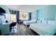 Spacious bedroom with two beds, desk, and balcony access at 611 Destiny Dr # 604, Ruskin, FL 33570