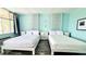 Nicely decorated bedroom with two beds and bedside storage at 611 Destiny Dr # 604, Ruskin, FL 33570