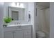 Bright bathroom features a modern vanity, framed mirror, and shower with white subway tile at 7321 Central Ave # 402, St Petersburg, FL 33710
