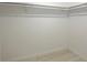 A simple white closet with a shelf and laminate flooring at 7321 Central Ave # 402, St Petersburg, FL 33710