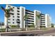 Multi-story building featuring private balconies, palm trees, and well-maintained landscaping at 7321 Central Ave # 402, St Petersburg, FL 33710
