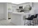 Modern kitchen with stainless steel appliances, a breakfast bar, and bright lighting at 7321 Central Ave # 402, St Petersburg, FL 33710