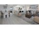 Bright living room featuring light wood floors, a modern kitchen, and stylish decor at 7321 Central Ave # 402, St Petersburg, FL 33710