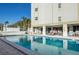 Inviting community pool with ample lounge seating and a building with multiple windows in the background at 7321 Central Ave # 402, St Petersburg, FL 33710