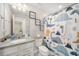 Charming bathroom featuring granite counters, a dinosaur-themed shower curtain, and cute decorative wall art at 7673 Yale Harbor Dr, Wesley Chapel, FL 33545