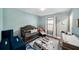 Cozy Bedroom features a gray crib, patterned rug, natural light from the window, and light blue walls at 7673 Yale Harbor Dr, Wesley Chapel, FL 33545
