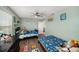 Shared bedroom with colorful decor, ceiling fan, and closet at 7673 Yale Harbor Dr, Wesley Chapel, FL 33545