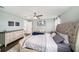Well-lit bedroom featuring a neutral color palette and a comfortable bed at 7673 Yale Harbor Dr, Wesley Chapel, FL 33545