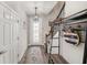 Bright foyer with wood flooring, decorative door, and a stylish coat rack at 7673 Yale Harbor Dr, Wesley Chapel, FL 33545