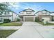 Charming two-story home featuring a well-maintained lawn and a two-car garage at 7673 Yale Harbor Dr, Wesley Chapel, FL 33545