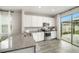 Kitchen featuring stainless steel appliances, granite counters, white cabinets and backyard views at 7673 Yale Harbor Dr, Wesley Chapel, FL 33545