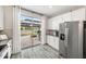 Kitchen featuring stainless steel appliances, white cabinets, granite counters and backyard views at 7673 Yale Harbor Dr, Wesley Chapel, FL 33545