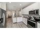 Bright kitchen featuring stainless steel appliances, white cabinets, and granite countertops at 7673 Yale Harbor Dr, Wesley Chapel, FL 33545