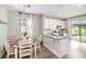 Eat-in kitchen features white cabinets, stainless appliances, granite counters, and backyard views at 7673 Yale Harbor Dr, Wesley Chapel, FL 33545