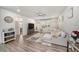 Inviting living room with a large sofa, wood floors and an open layout at 7673 Yale Harbor Dr, Wesley Chapel, FL 33545