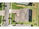 An aerial view of the home's roof and a brick paved driveway surrounded by well-kept lawns at 7721 Roma Dune Dr, Wesley Chapel, FL 33545