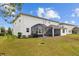 A view of the back of the home, showcasing the screened in porch and outdoor spaces at 7721 Roma Dune Dr, Wesley Chapel, FL 33545