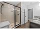 Bathroom with tiled shower featuring a glass enclosure and a granite vanity with double sinks at 7721 Roma Dune Dr, Wesley Chapel, FL 33545