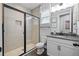 Bathroom with granite counter, new shower with black trim, and tile flooring at 7721 Roma Dune Dr, Wesley Chapel, FL 33545