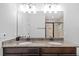 Bathroom with dual sinks, granite countertops, and a glass-enclosed shower at 7721 Roma Dune Dr, Wesley Chapel, FL 33545