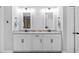 Bathroom featuring dual sinks with granite countertops, and modern white cabinets and hardware at 7721 Roma Dune Dr, Wesley Chapel, FL 33545