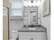 Guest bathroom features a granite countertop, framed mirror, and elegant decor at 7721 Roma Dune Dr, Wesley Chapel, FL 33545