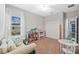 A bedroom with a white couch, carpeted floors, and lots of toys at 7721 Roma Dune Dr, Wesley Chapel, FL 33545