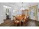 Formal dining room features wood flooring, coffered ceiling, china cabinet, and bar area at 7721 Roma Dune Dr, Wesley Chapel, FL 33545