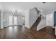 Elegant foyer with beautiful tile floors, chandelier, staircase and open layout at 7721 Roma Dune Dr, Wesley Chapel, FL 33545