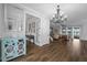 Elegant foyer with tile floors, chandelier, and view into the living room at 7721 Roma Dune Dr, Wesley Chapel, FL 33545
