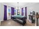Bright game room featuring a ping pong table, hardwood floors, and decorative purple window treatments at 7721 Roma Dune Dr, Wesley Chapel, FL 33545