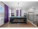 Upstairs game room featuring a ping pong table, hardwood floors, and decorative purple window treatments at 7721 Roma Dune Dr, Wesley Chapel, FL 33545