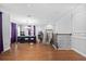 Large game room with hardwood flooring, pool table, staircase, and high ceilings at 7721 Roma Dune Dr, Wesley Chapel, FL 33545