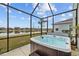 Hot tub on the patio overlooking a tranquil lake and neighborhood homes at 7721 Roma Dune Dr, Wesley Chapel, FL 33545