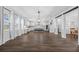 Spacious open kitchen featuring hardwood floors, white cabinets, a central island, and modern lighting at 7721 Roma Dune Dr, Wesley Chapel, FL 33545