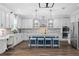 Well-lit kitchen featuring a large island with seating, stylish backsplash, and stainless steel appliances at 7721 Roma Dune Dr, Wesley Chapel, FL 33545