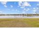 Picturesque lake view showing the water extending to the horizon with homes lining the far edge of the water at 7721 Roma Dune Dr, Wesley Chapel, FL 33545