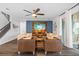 Stylish living room with hardwood floors, modern furniture, ceiling fan, and mounted TV at 7721 Roma Dune Dr, Wesley Chapel, FL 33545